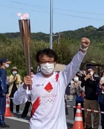 Mr. Nose holding Olympic torch